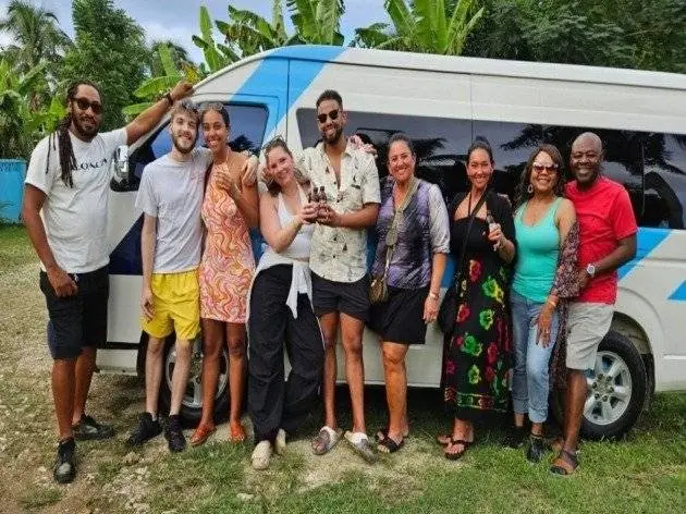 Guests beside a KB Opulence private transportation vehicle